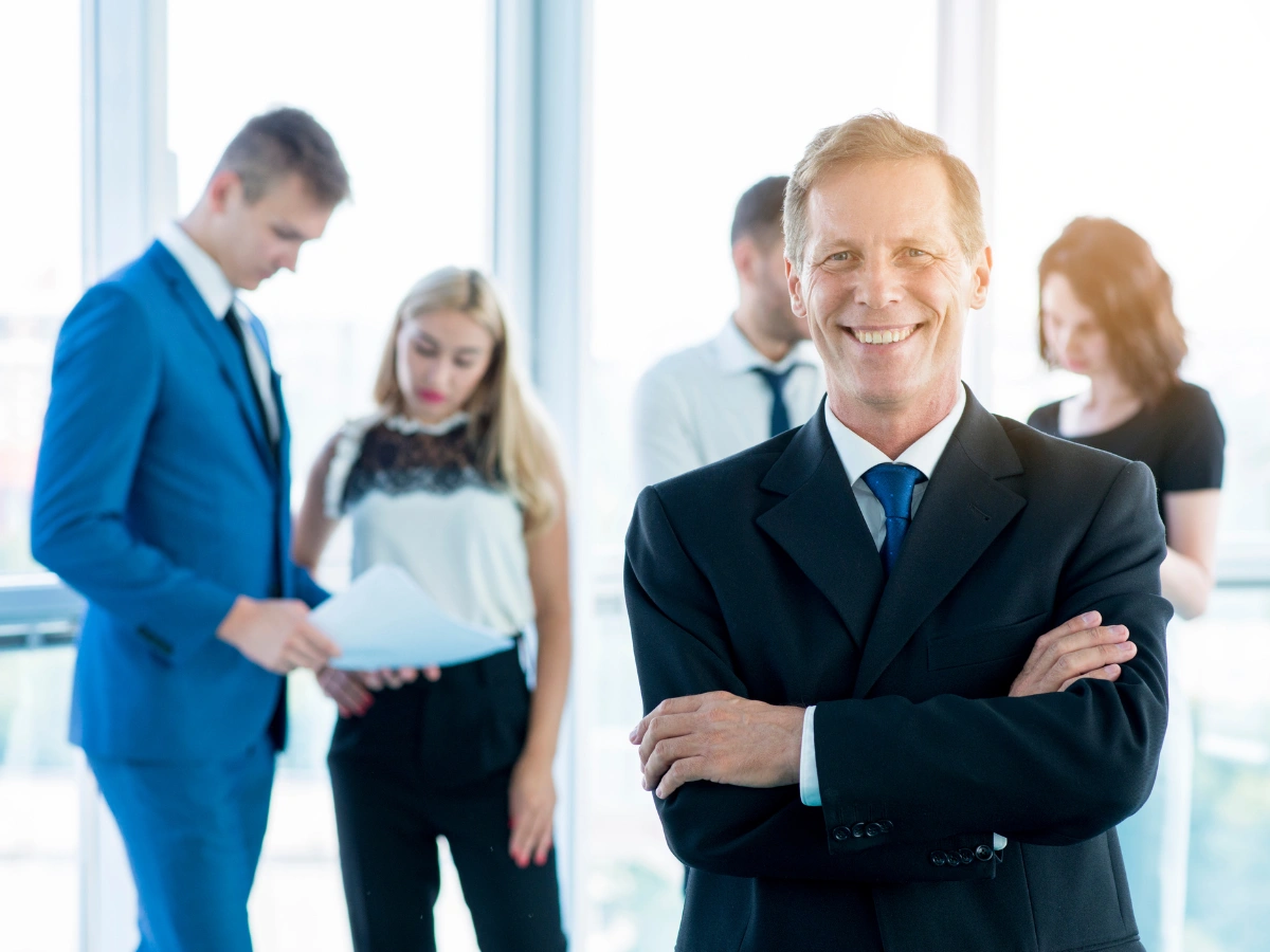 Corporate professionals in formal business attire at an office, representing a premium uniform supplier in UAE